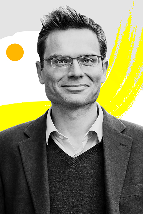 Economist Nicholas Bloom surrounded by colorful graphic designs